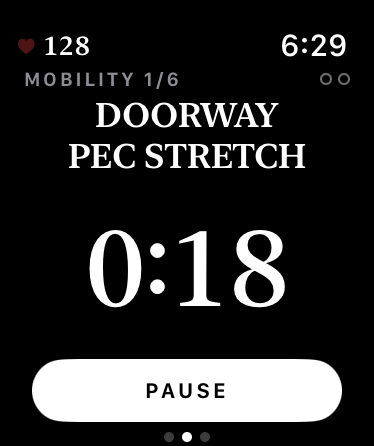 Your watch running a mobility hold: the Doorway Pec Stretch counting down with a Pause button.